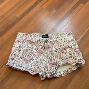 Red and white floral printed denim shorts